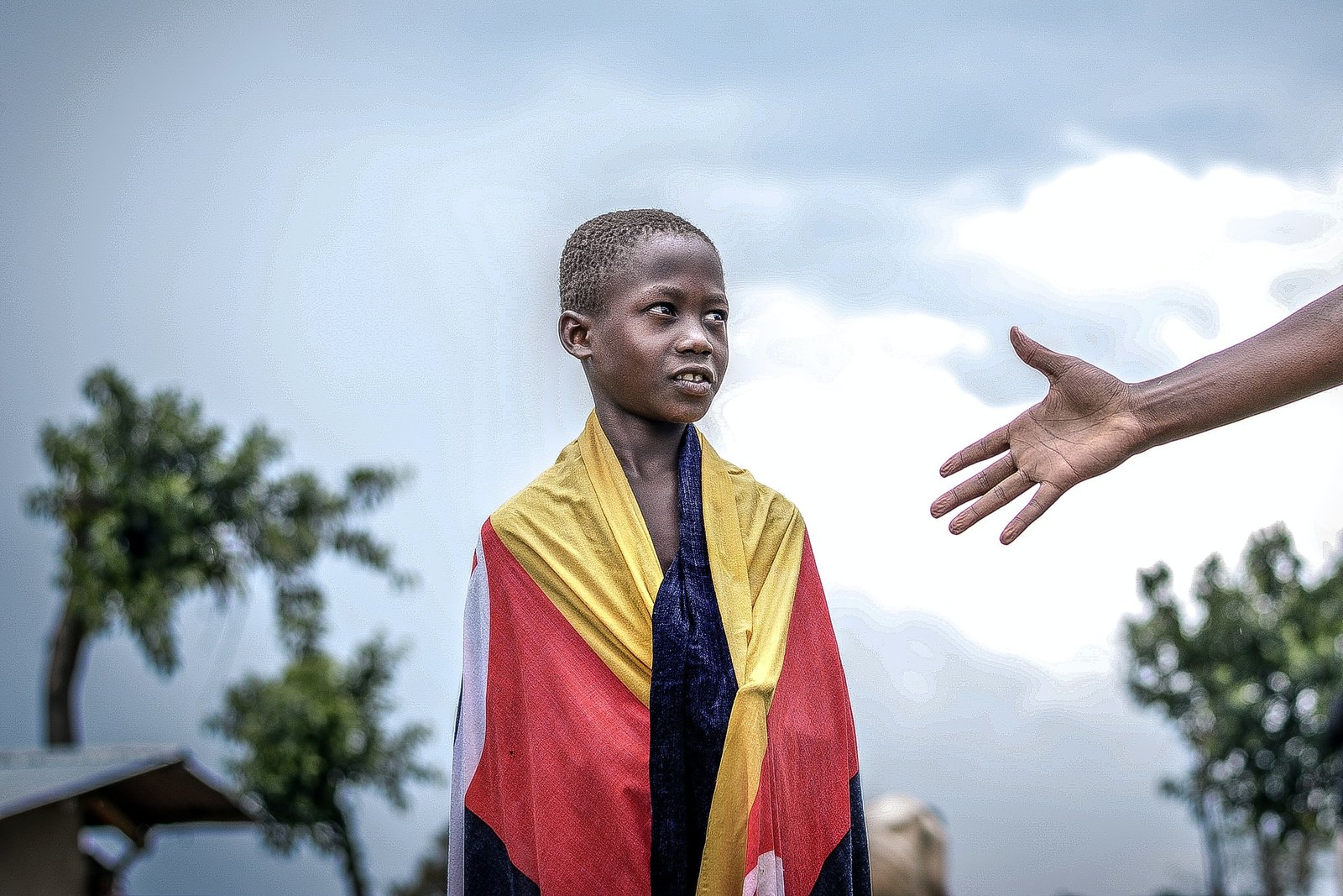 african-boy-looking-at-a-raised-hand.jpg