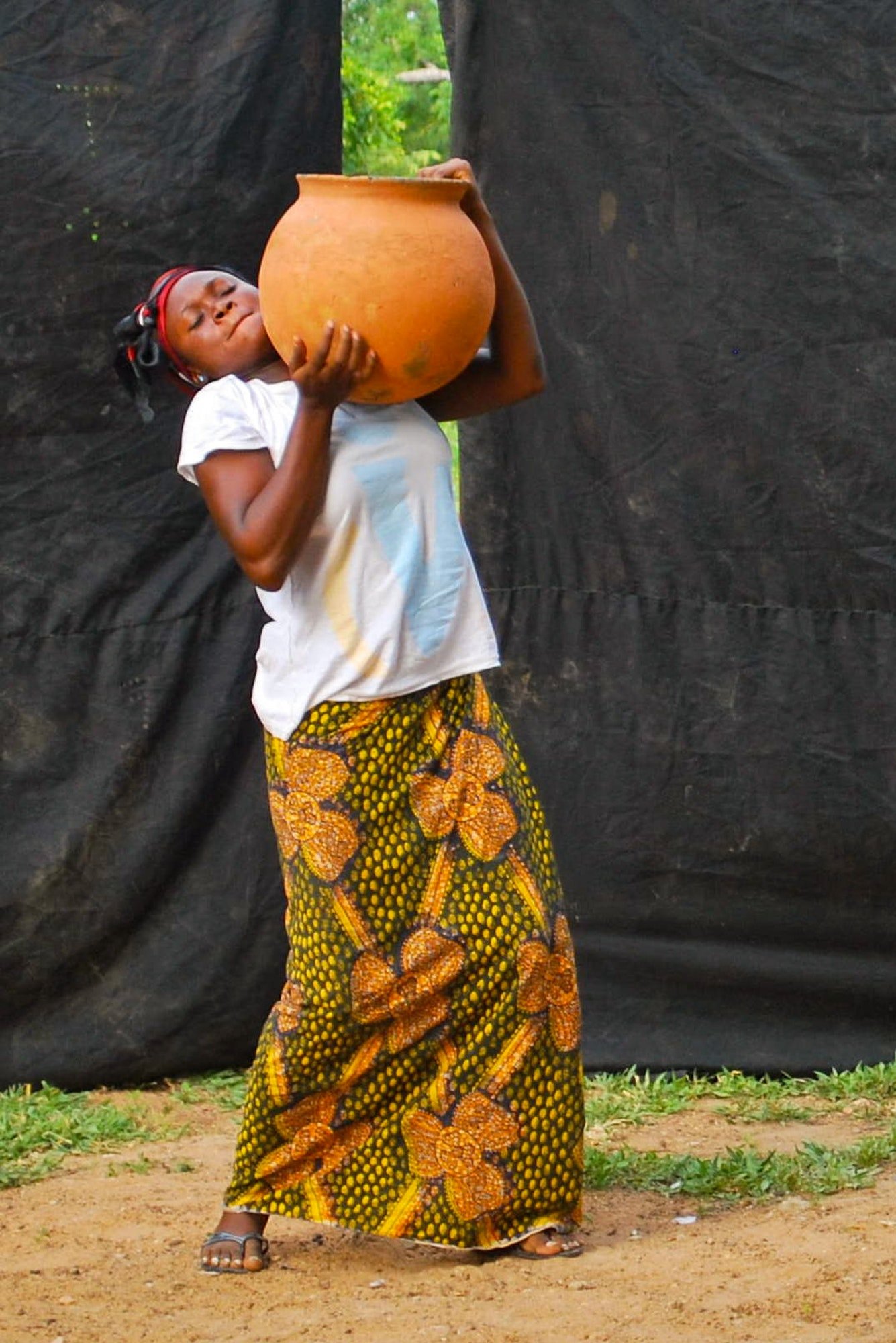 african-lady-wearing-a-big-jug-of-water-wearing-traditional-african-clothes.jpg