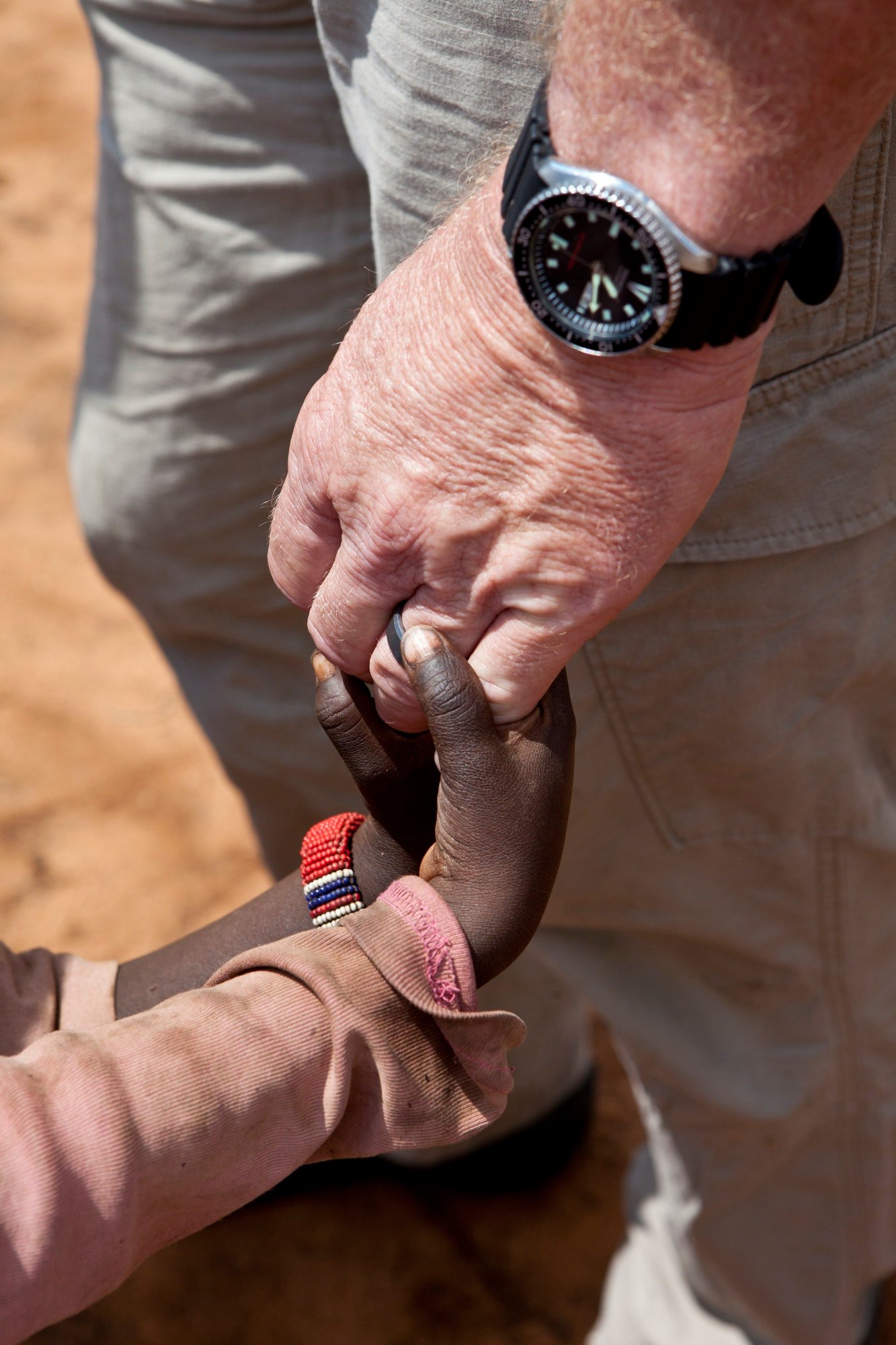 aid-worker-s-hands-holding-children-s-hands.jpg